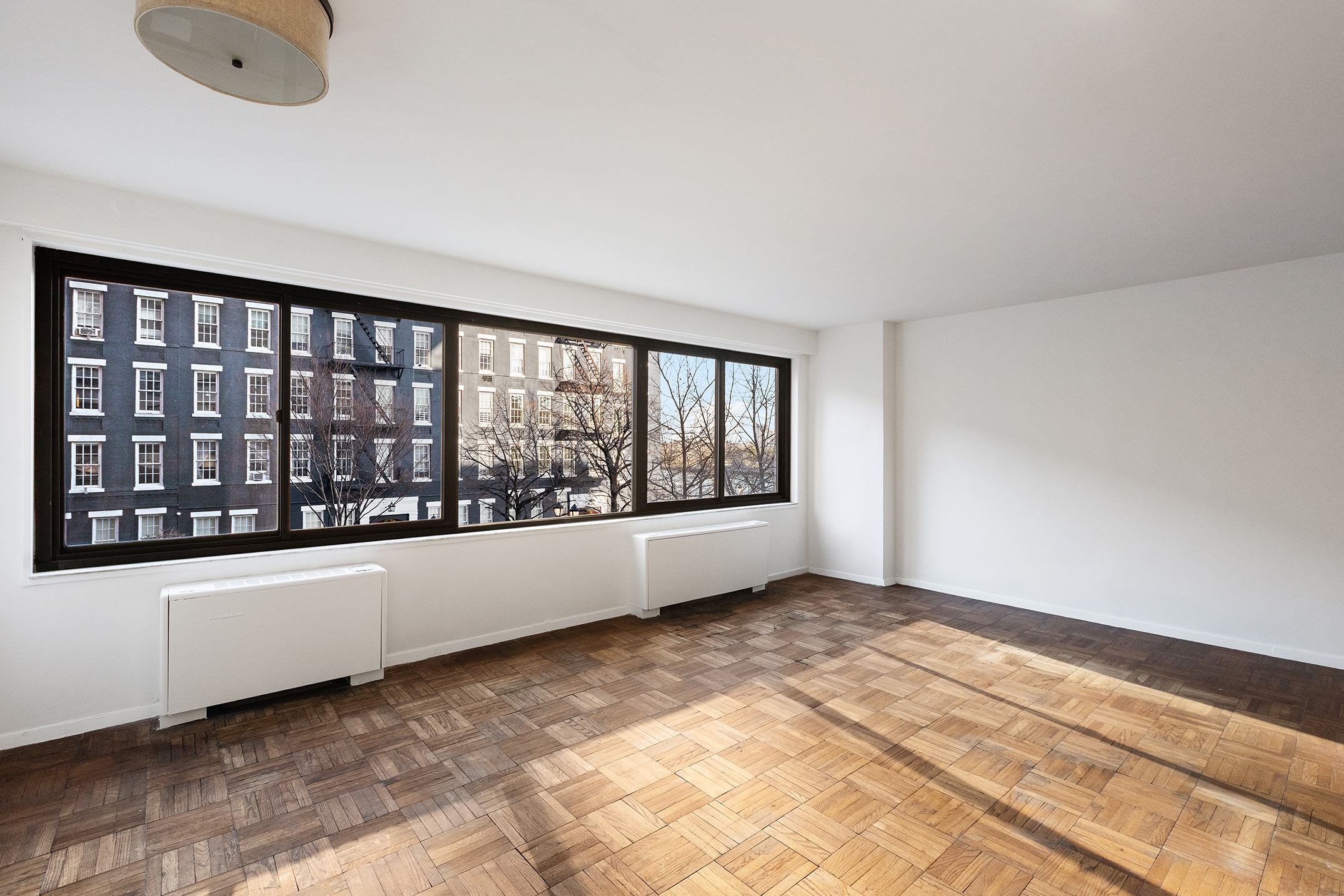 530 East 72nd Street, Unit 3C Manhattan, NY 10021 - Photo 4 of 10 a view of an empty room with a window