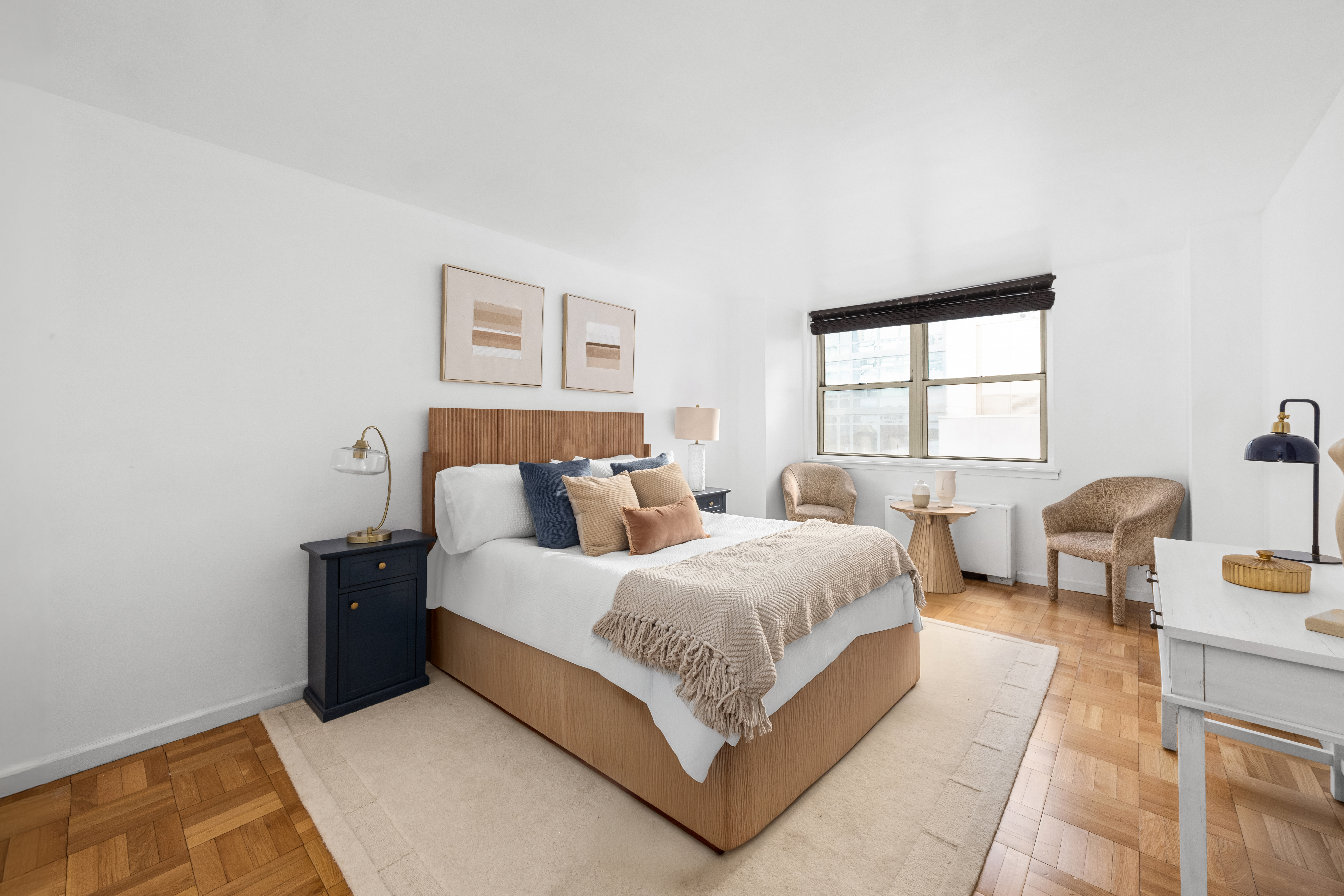 200 East 58th Street, Unit 6B Manhattan, NY 10022 - Photo 9 of 12 a spacious bedroom with a bed and window