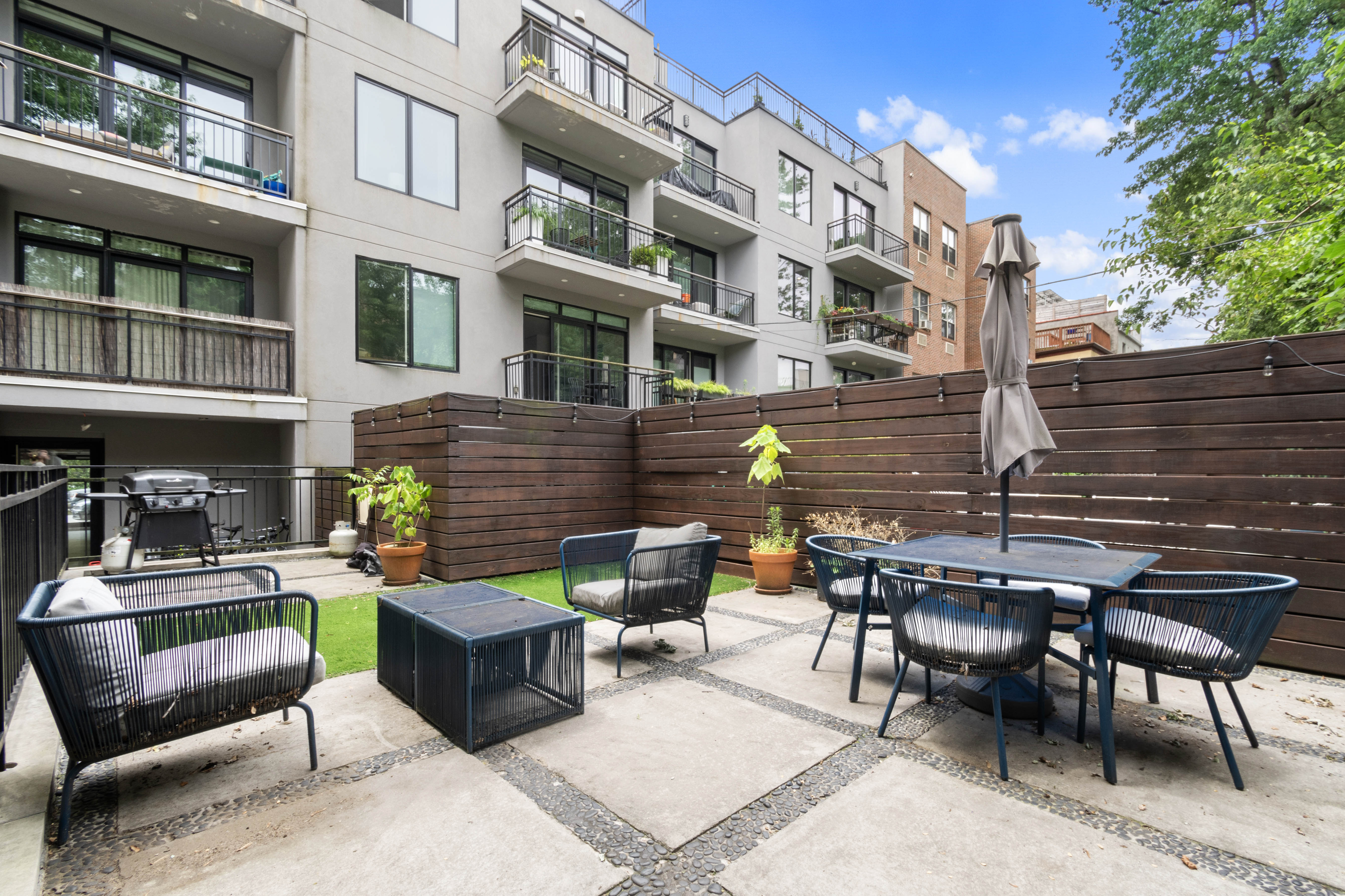 203 Quincy Street, Unit 4B Brooklyn, NY 11216 - Photo 11 of 11 a view of a patio with couches table and chairs and potted plants