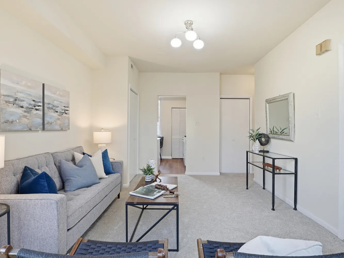 a living room with furniture a rug and a chandelier