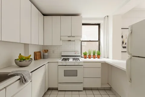 a kitchen with a stove a refrigerator and a sink