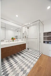 a bathroom with a tub a sink and a shower