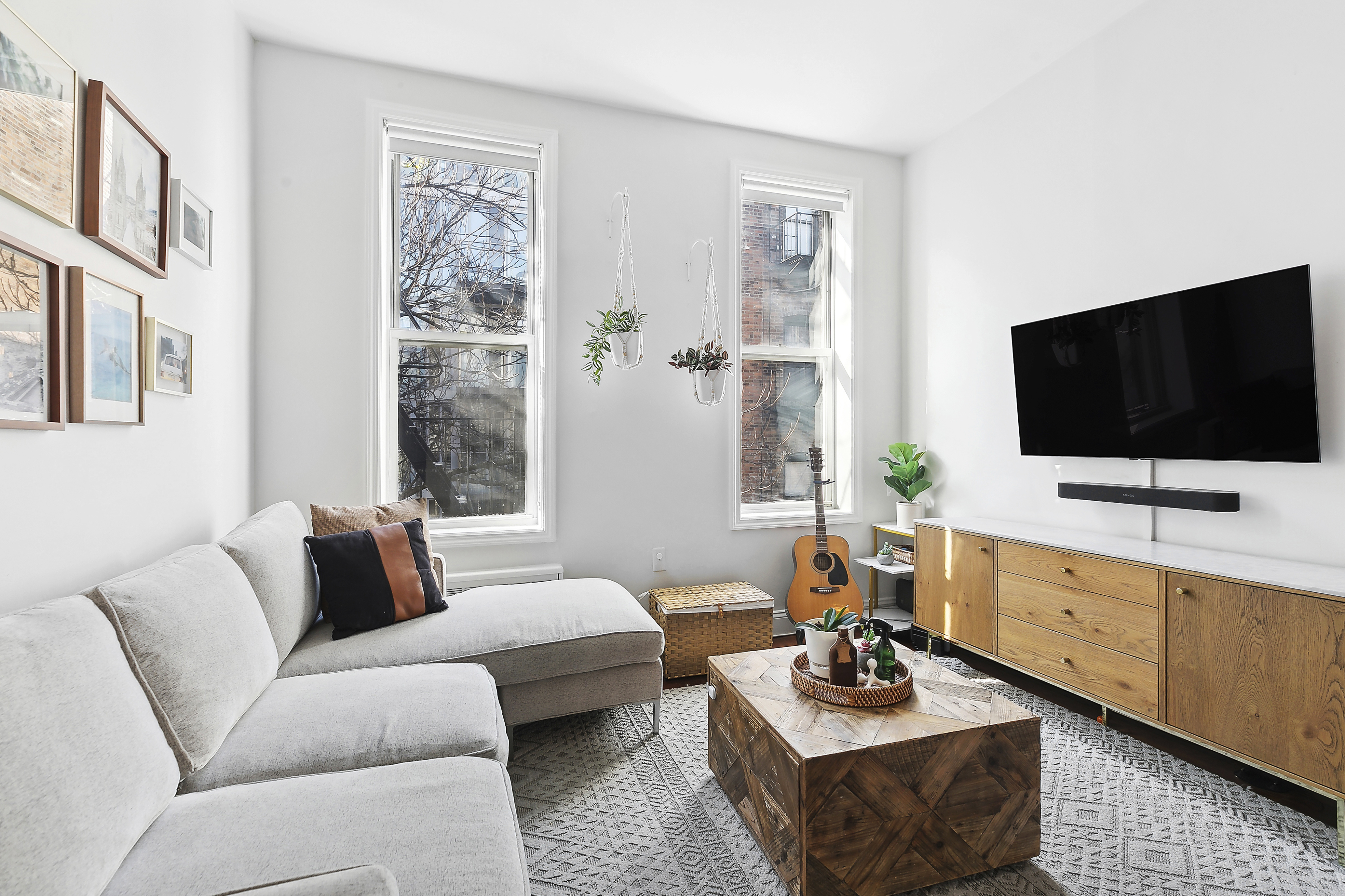 406 West 46th Street, Unit 4C Manhattan, NY 10036 - Photo 3 of 9 a living room with furniture and a flat screen tv