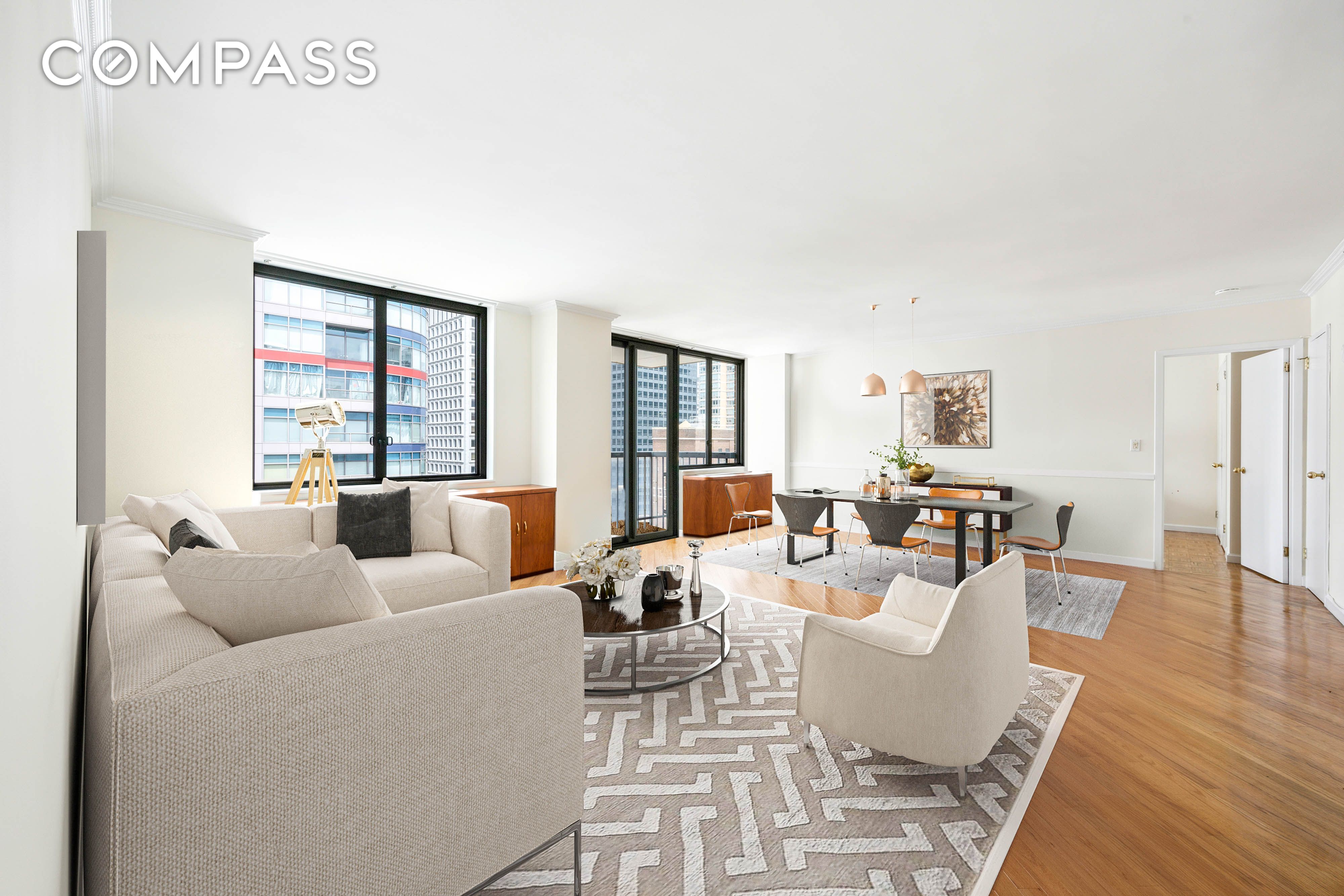 300 East 54th Street, Unit 34GF Manhattan, NY 10022 - Photo 1 of 16 a living room with furniture wooden floor and a large window