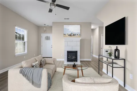 a living room with furniture and a flat screen tv