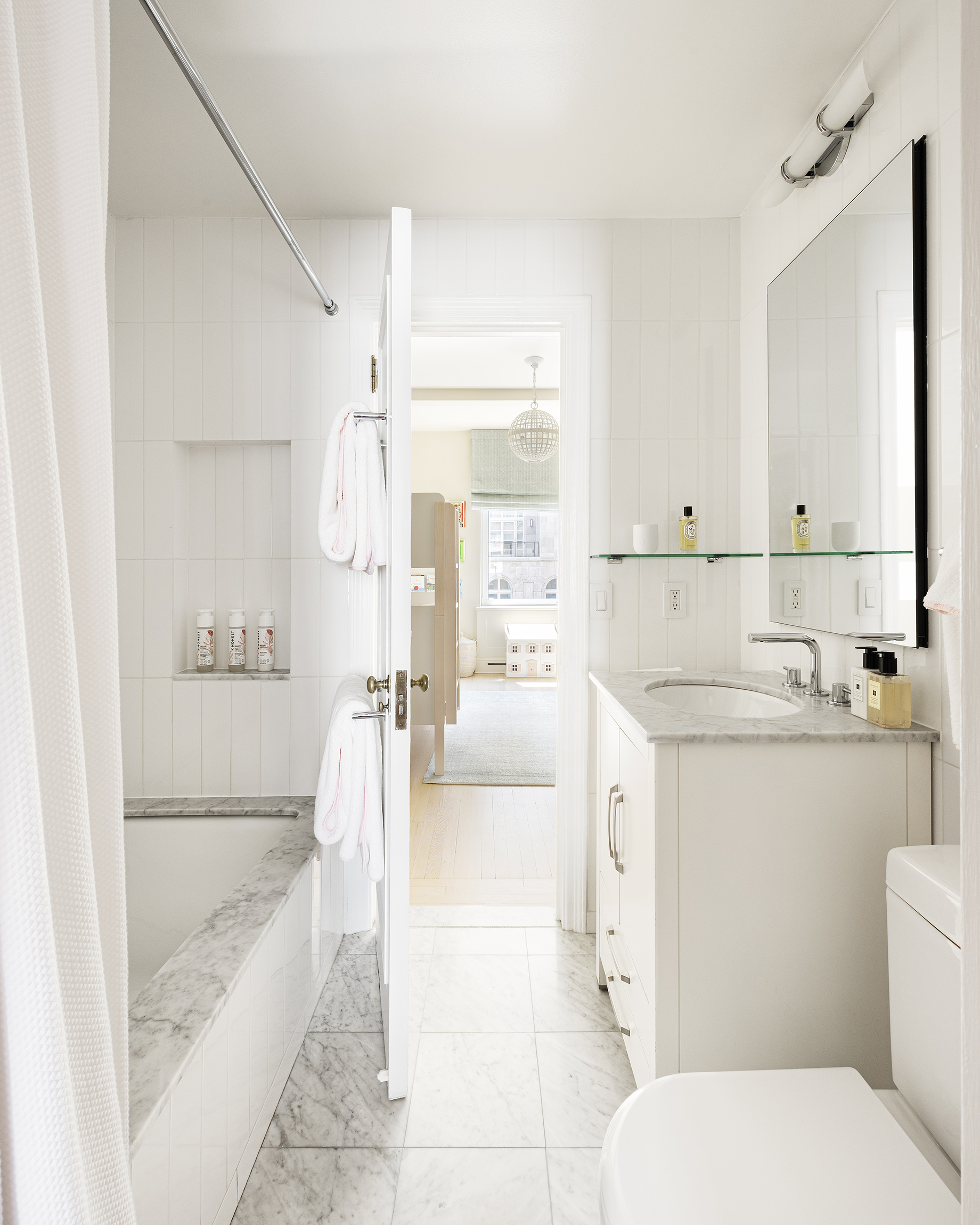 49 East 86th Street, Unit 11A Manhattan, NY 10028 - Photo 9 of 10 a bathroom with a granite countertop sink mirror vanity and toilet