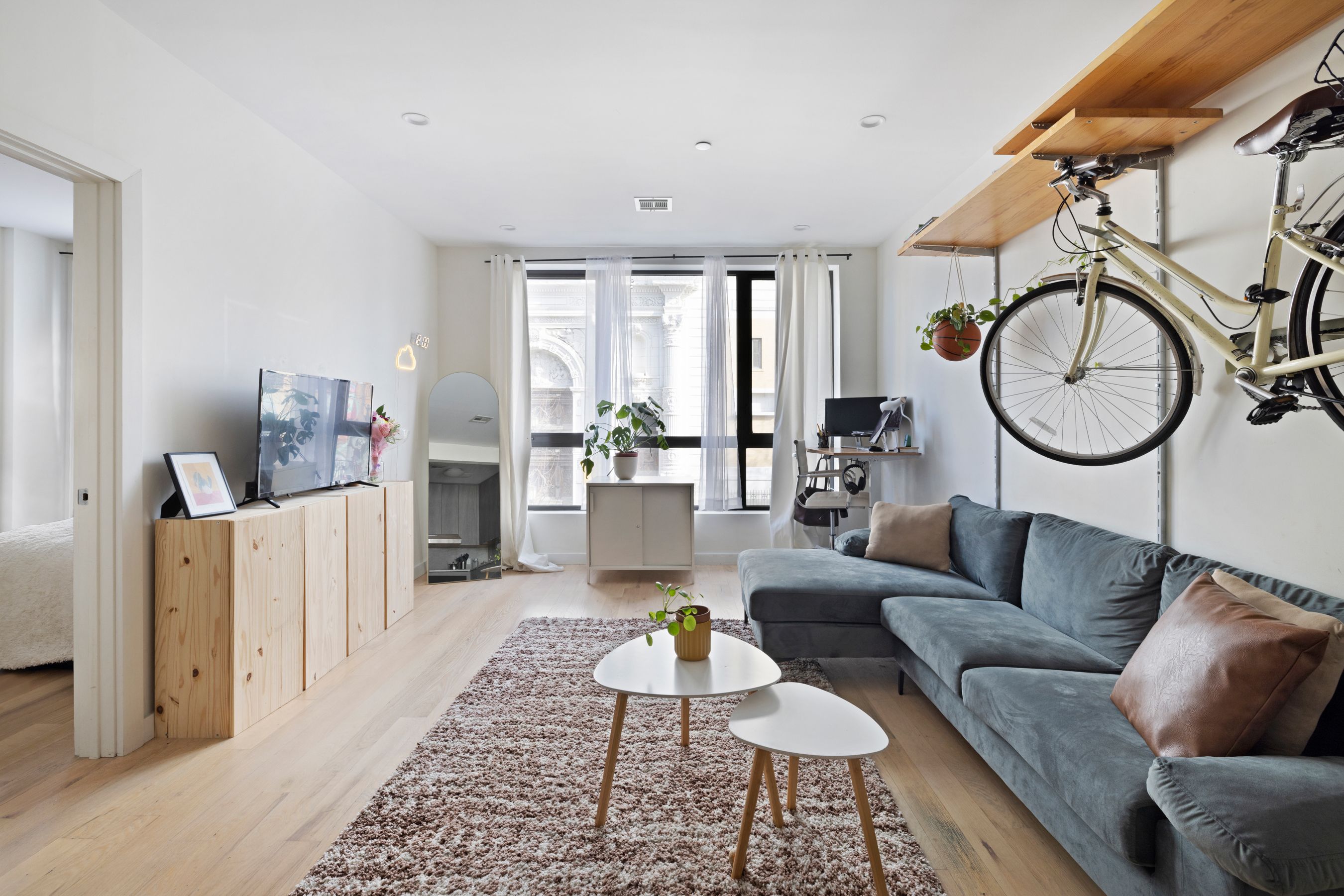 328 Central Avenue, Unit 2A Brooklyn, NY 11221 - Photo 2 of 7 a living room with furniture a rug a lamp and a window