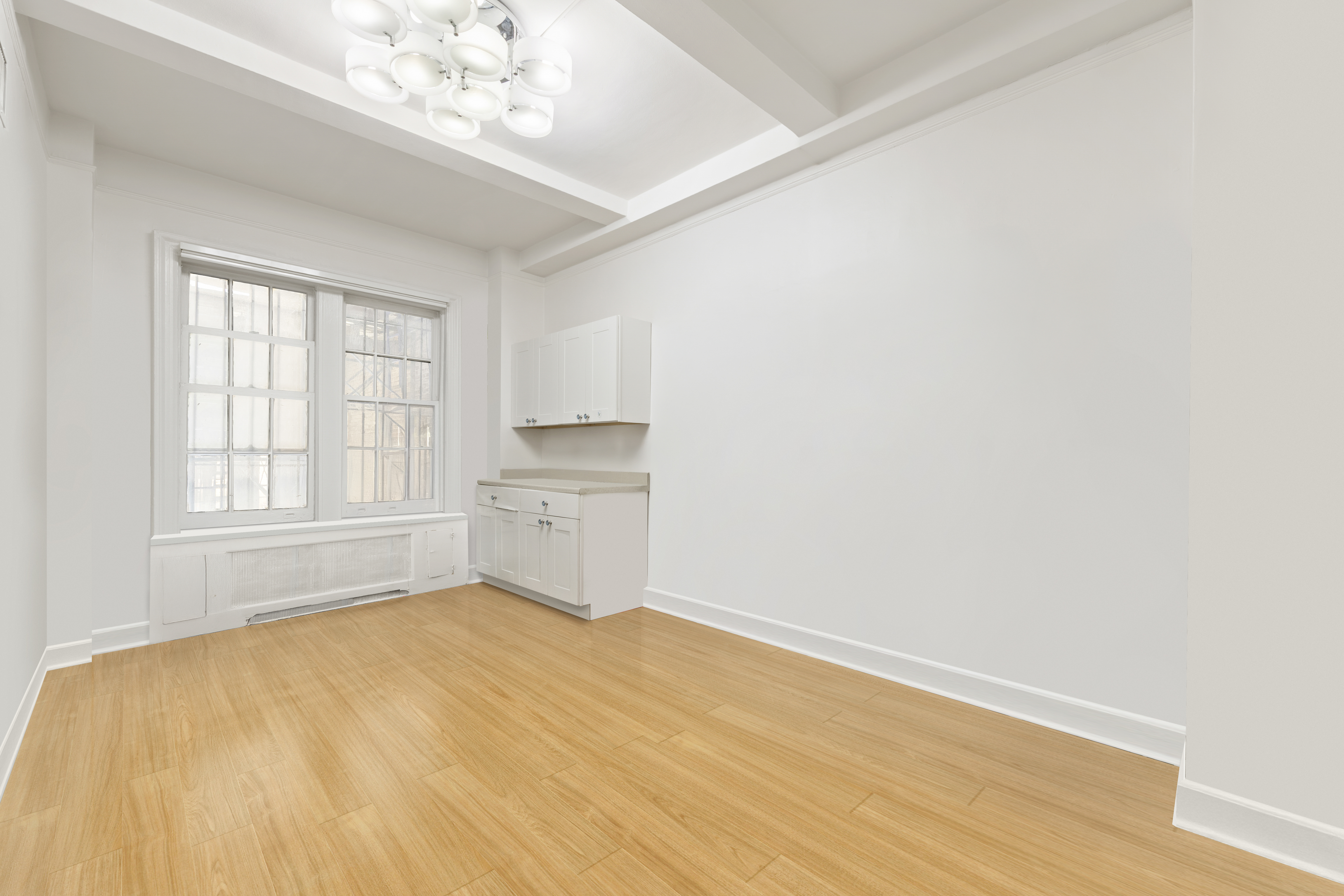 162 East 80th Street, Unit 1B Manhattan, NY 10075 - Photo 5 of 10 a big room with wooden floor and windows in a room