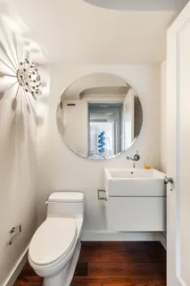 a bathroom with a sink mirror and toilet