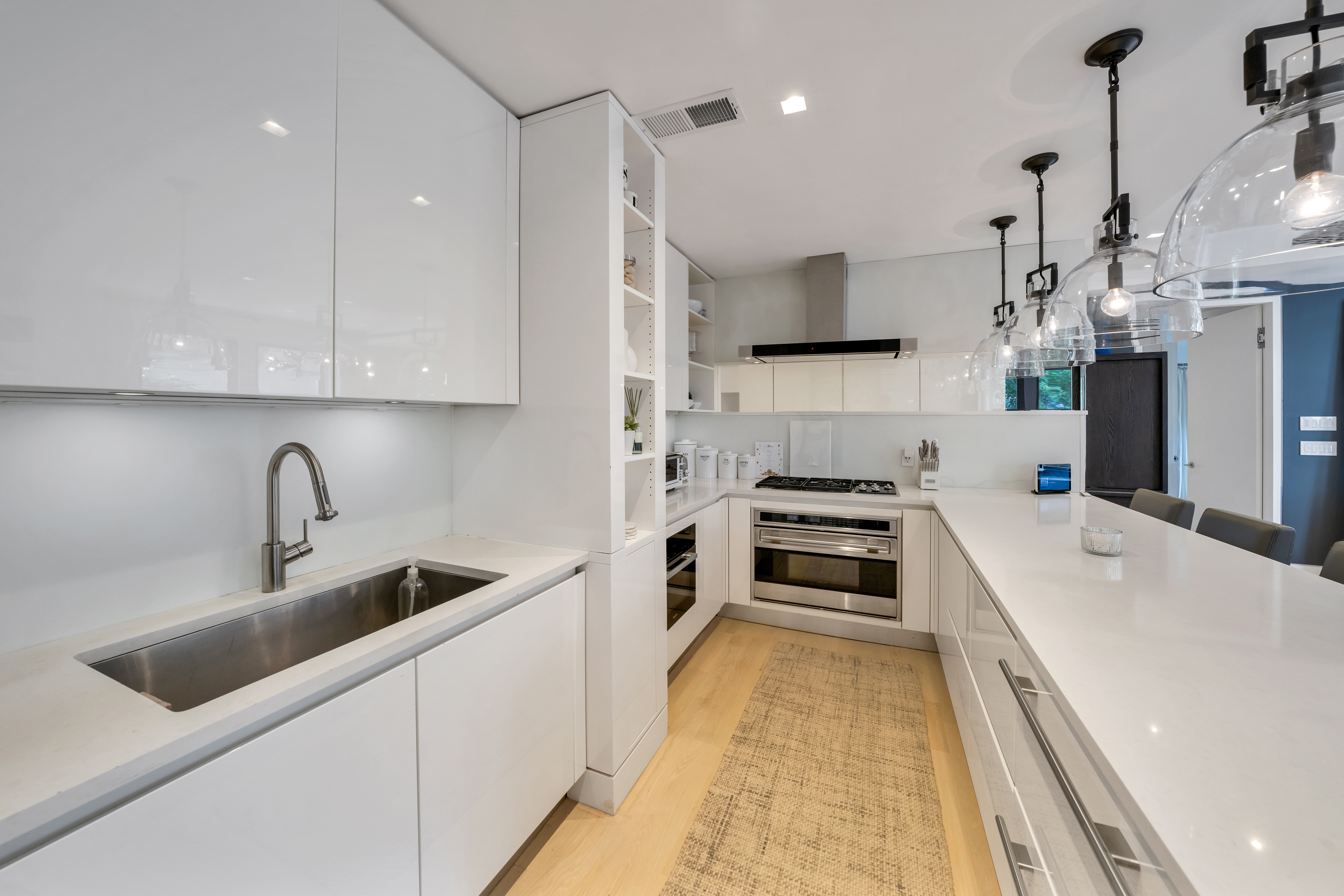 67 Park Avenue, Unit 2BC Manhattan, NY 10016 - Photo 6 of 16 a kitchen with kitchen island white cabinets and stainless steel appliances