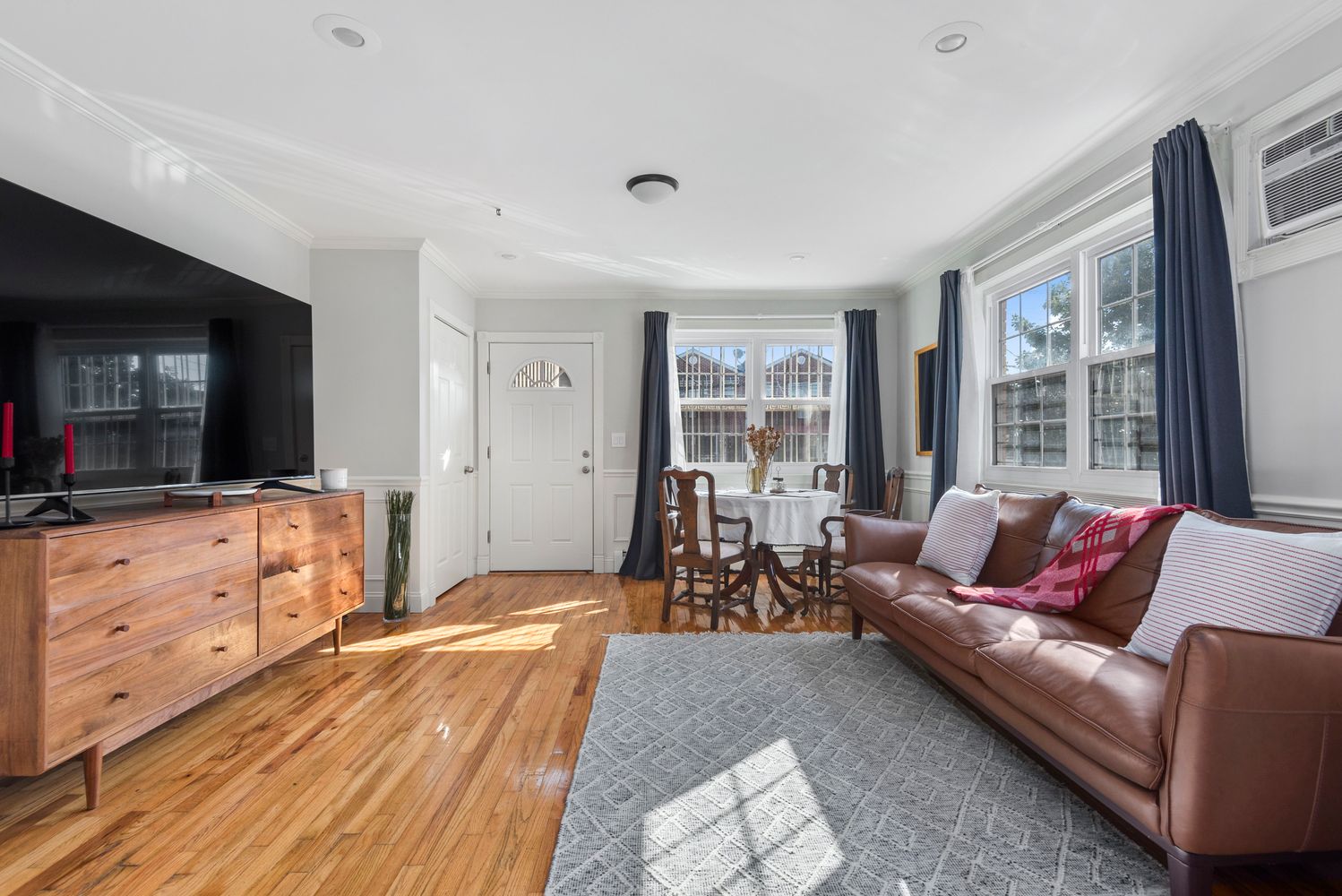 756 Barbey Street, Unit 1A Brooklyn, NY 11207 - Photo 1 of 9 a living room with furniture and a flat screen tv