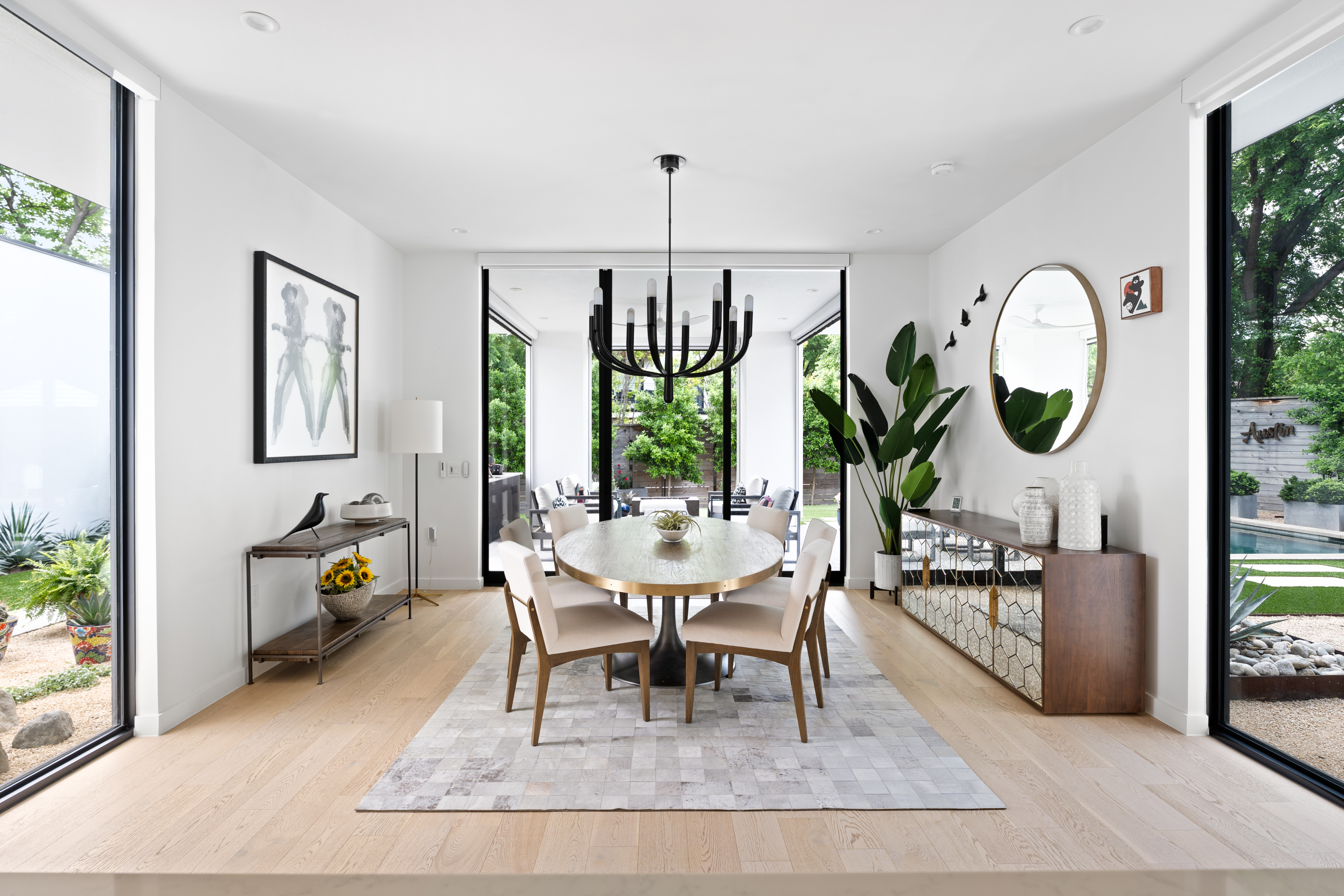 Address Upon Request Austin, TX 78704 - Photo 8 of 27 a living room with furniture a chandelier a rug and a large window
