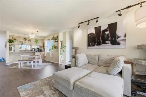 a living room with furniture and a glass door