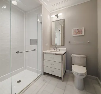a bathroom with a toilet sink and shower