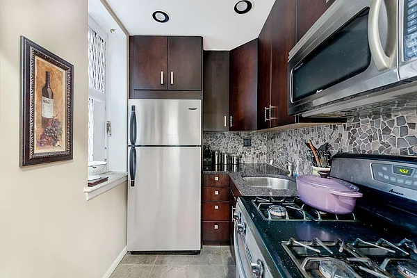 61 Lexington Avenue, Unit 4F Manhattan, NY 10010 - Photo 2 of 6 a kitchen with stainless steel appliances granite countertop a stove and a refrigerator