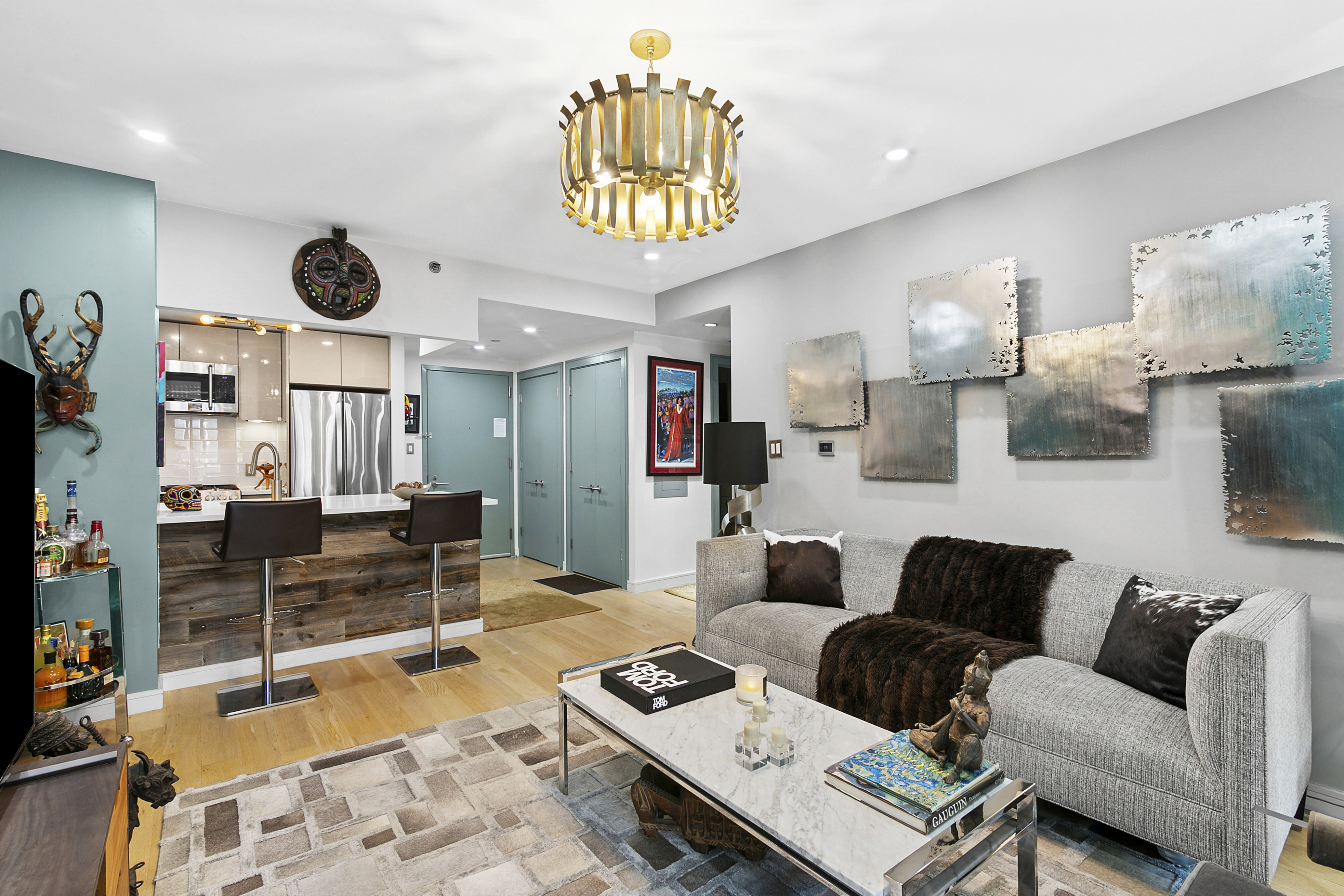 a living room with furniture a rug and a chandelier