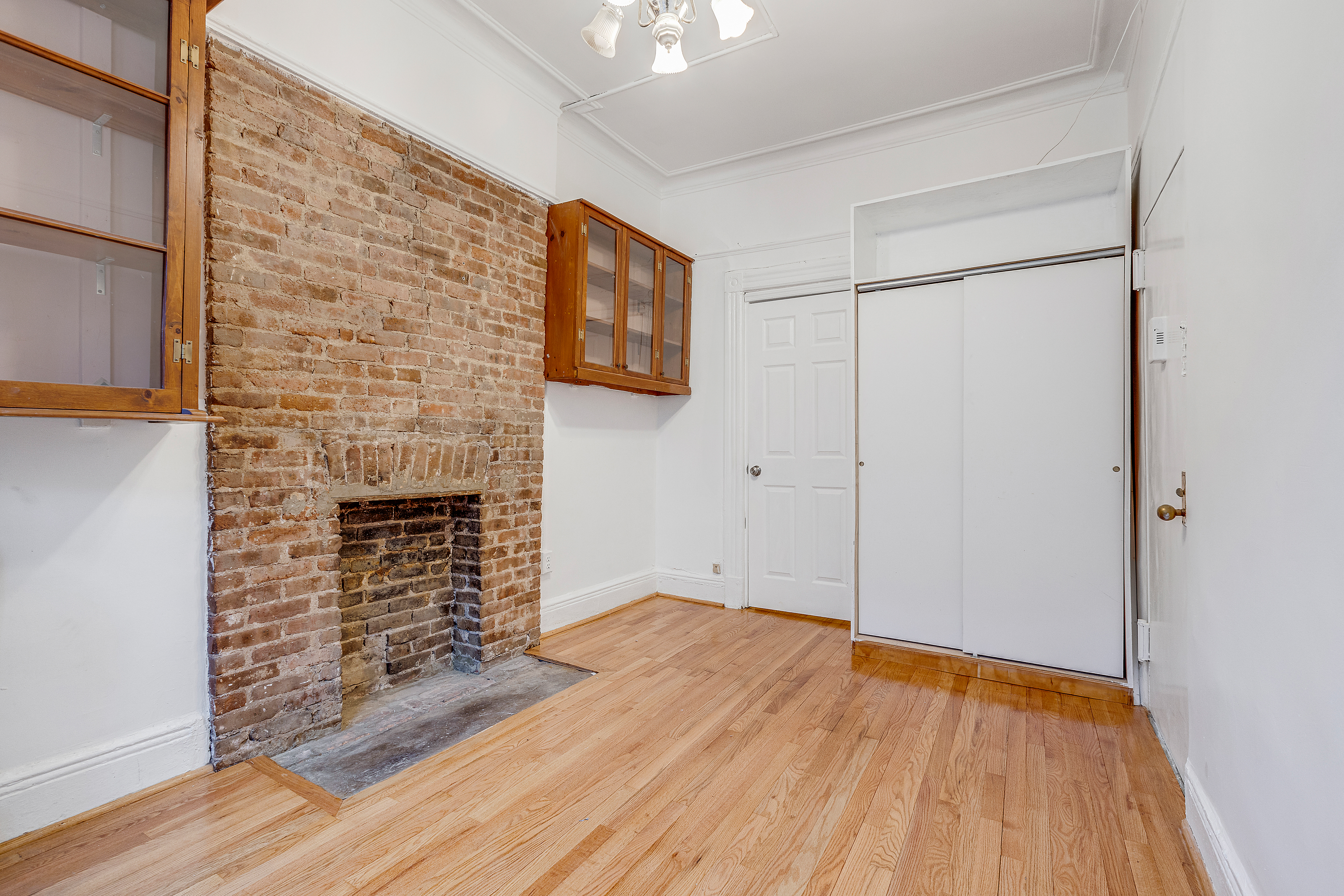 639 President Street, Unit 1L Brooklyn, NY 11215 - Photo 10 of 12 a view of empty room with wooden floor and fireplace