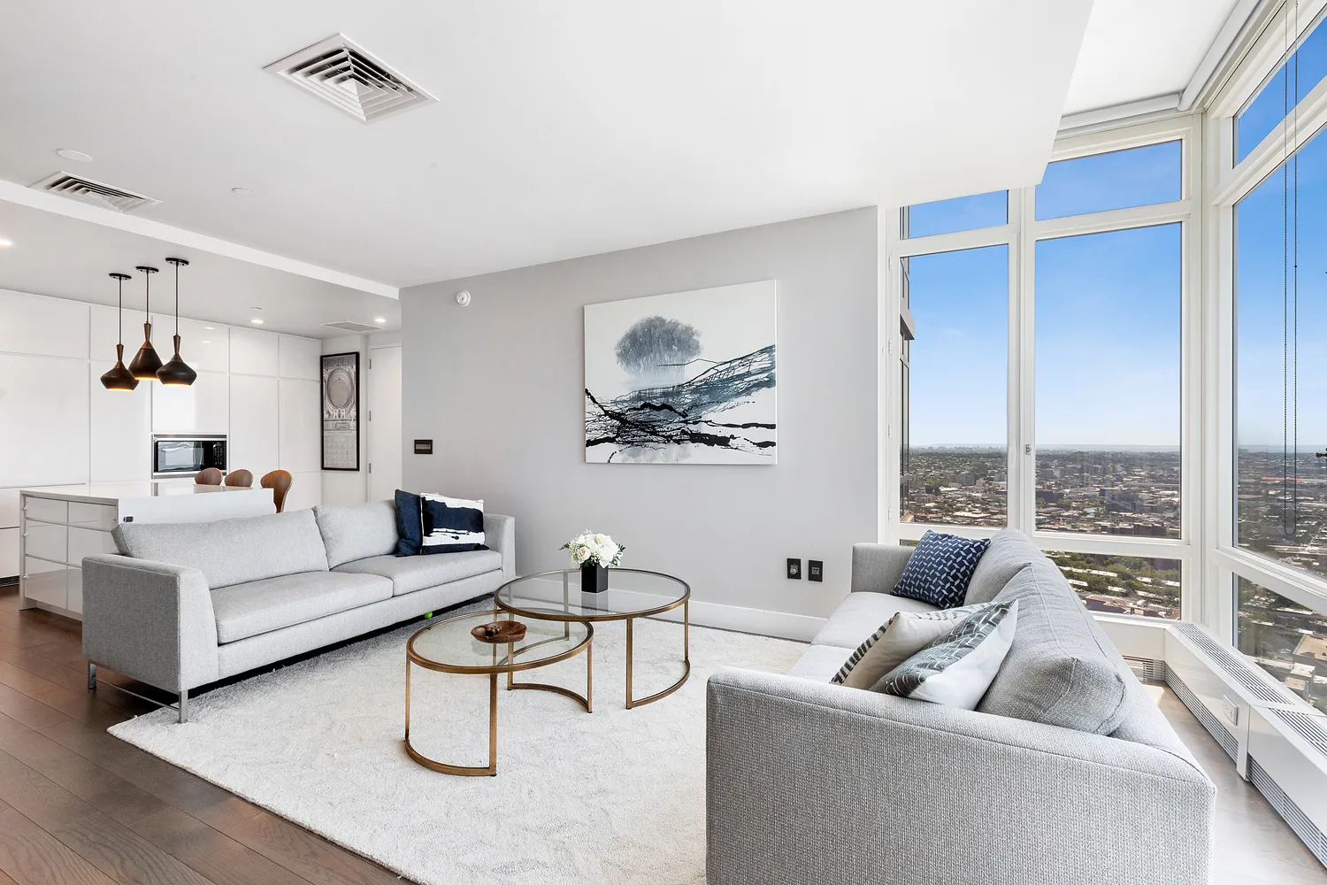 a living room with furniture floor to ceiling window and a table