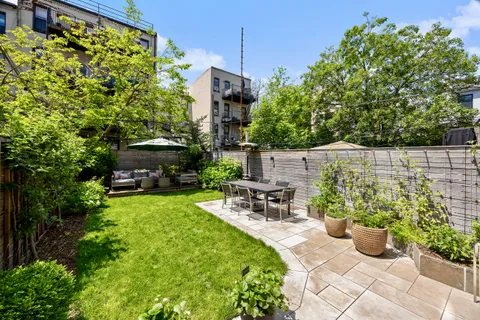 a view of a chair and table in the garden