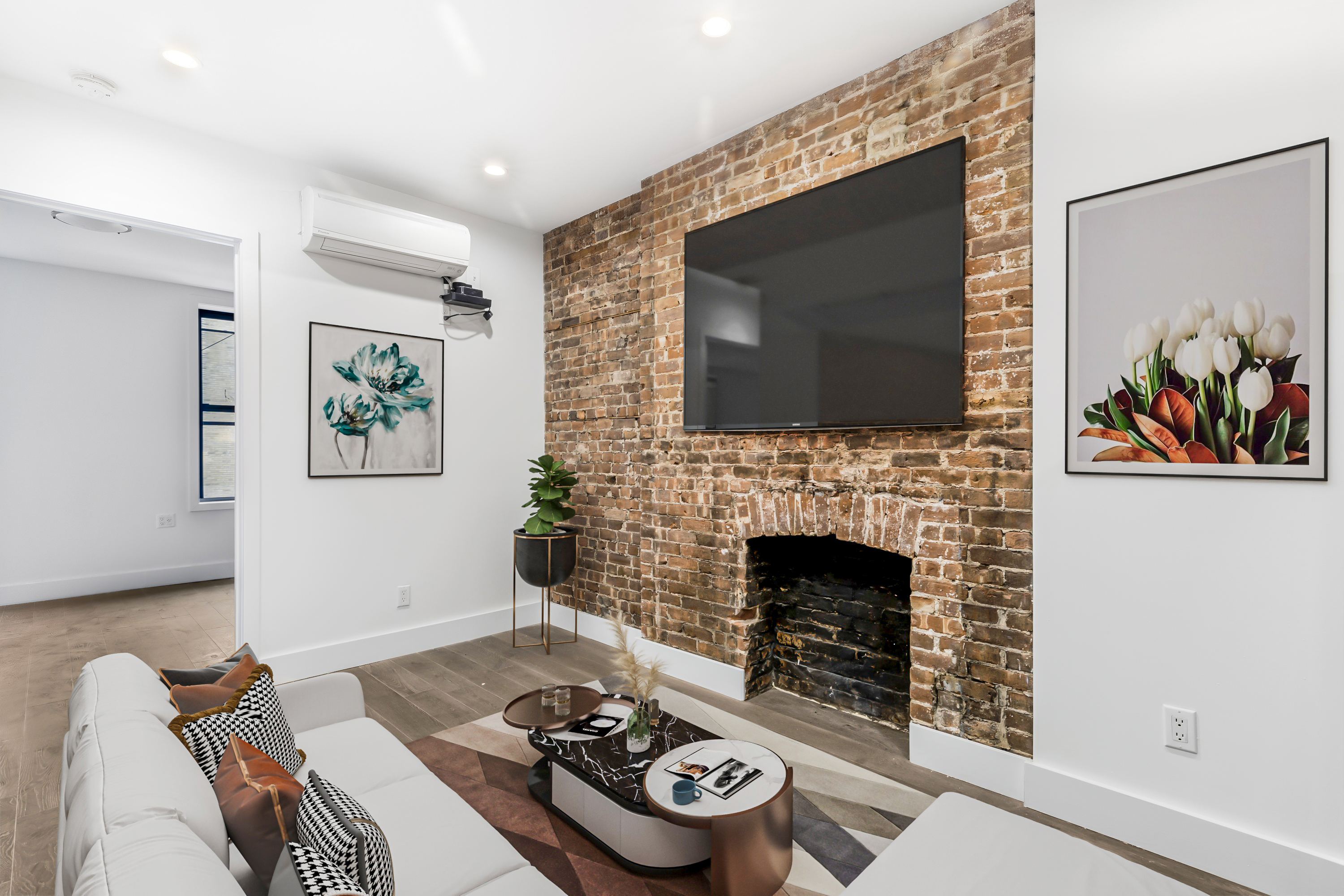 a living room with furniture a fireplace and a flat screen tv