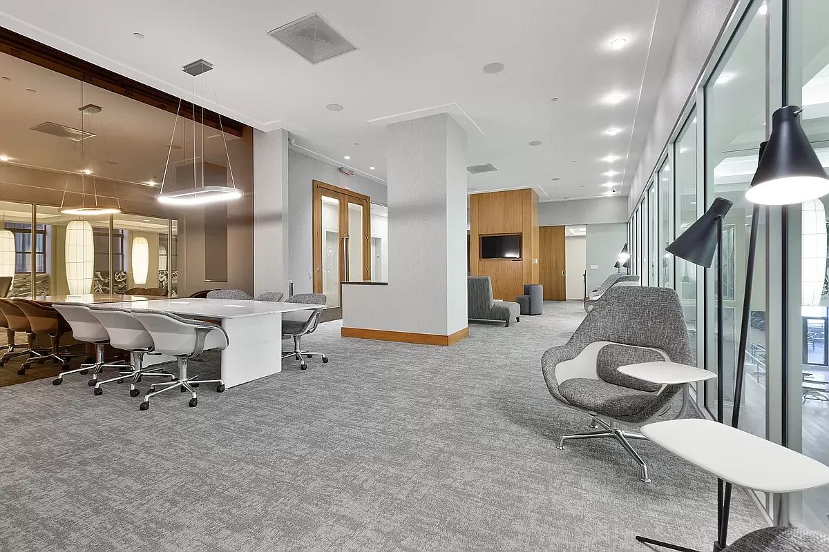 20 West Street, Unit 31C Manhattan, NY 10004 - Photo 9 of 16 a living room with furniture and a large window
