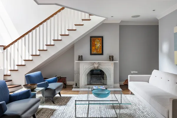 a living room with furniture fireplace and a table