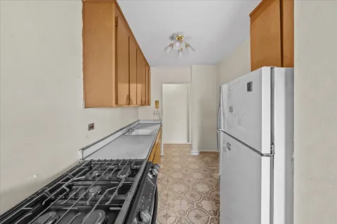 a kitchen with a refrigerator and a stove
