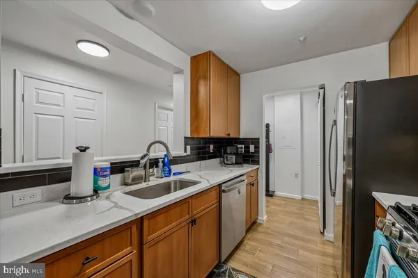 a kitchen with a sink and a refrigerator