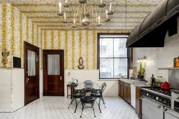 a kitchen with a table chairs and a window