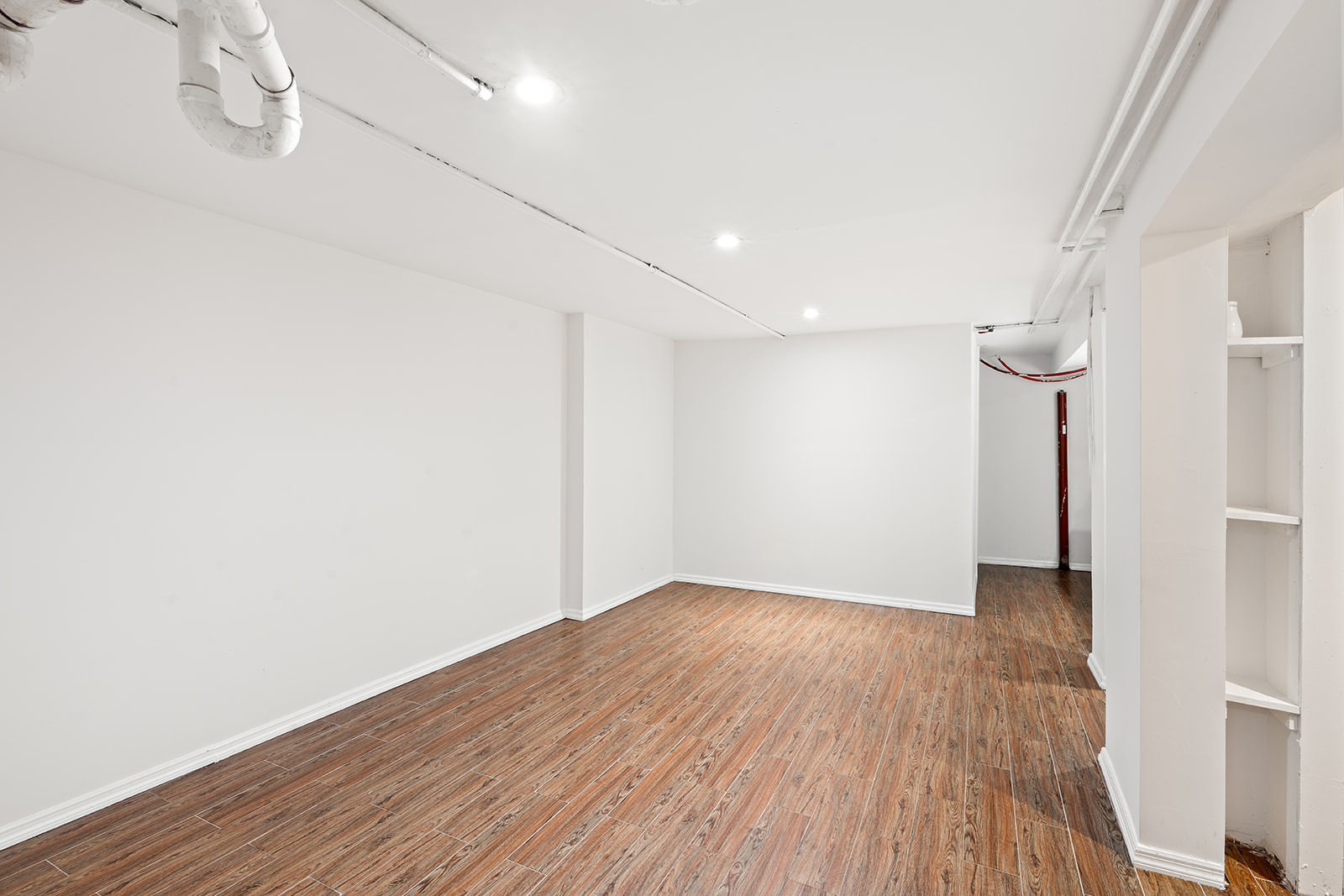 383 Bainbridge Street, Unit 1 Brooklyn, NY 11233 - Photo 12 of 14 a view of an empty room with wooden floor and a window