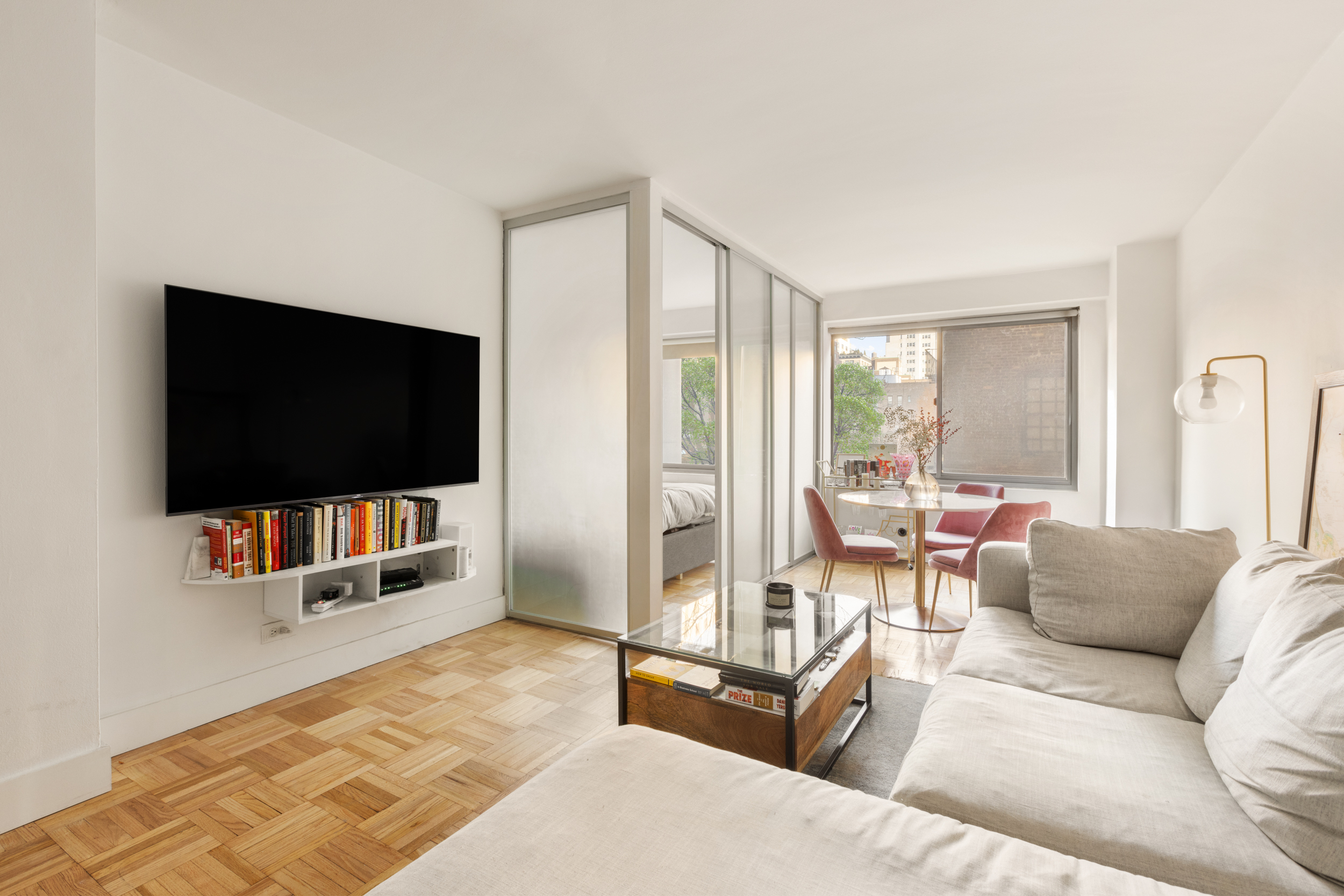 175 West 12th Street, Unit 5M Manhattan, NY 10011 - Photo 3 of 10 a living room with furniture and a flat screen tv