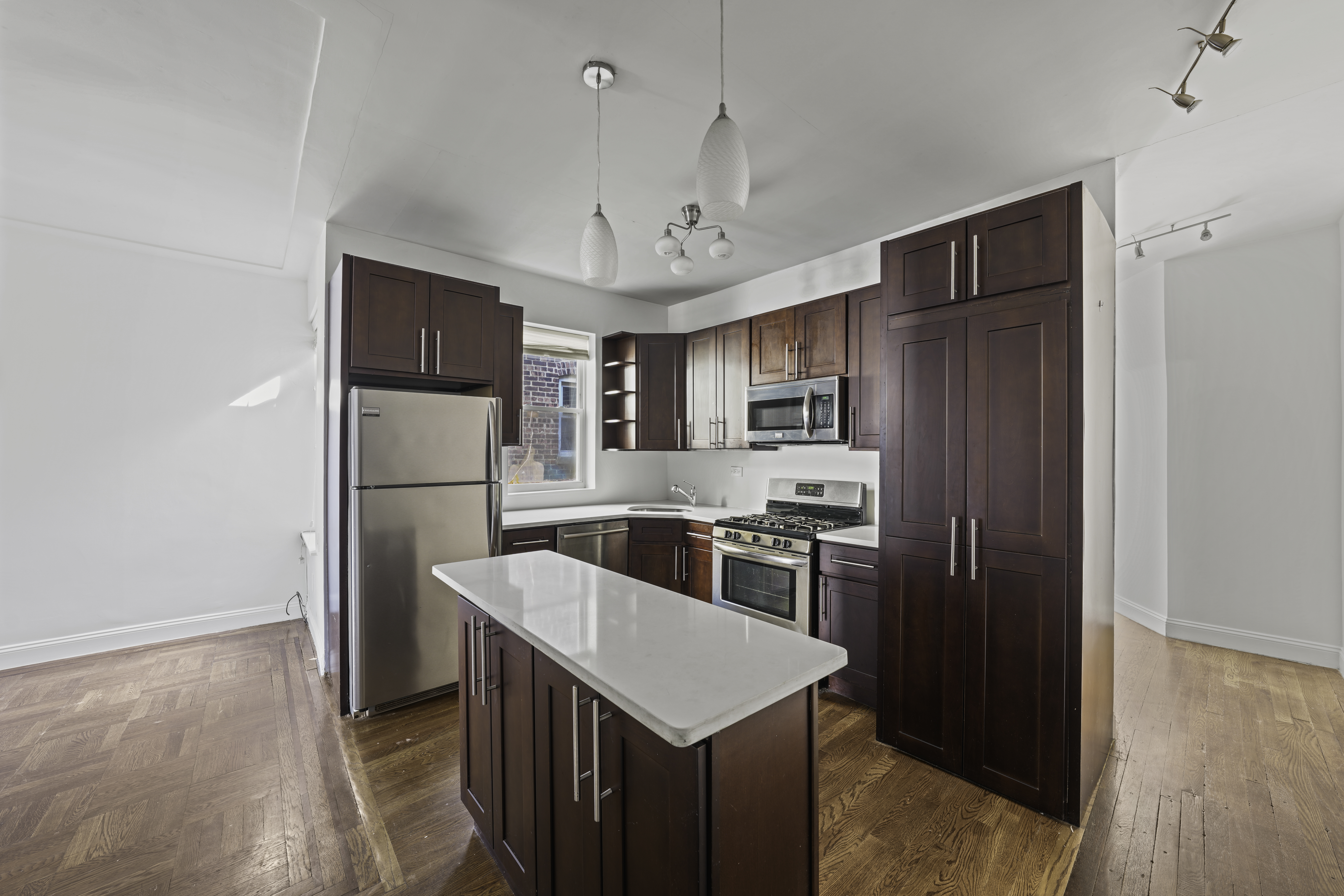 514 86th Street, Unit 4 Brooklyn, NY 11209 - Photo 2 of 19 a kitchen with stainless steel appliances granite countertop a refrigerator a sink dishwasher a stove with wooden floor