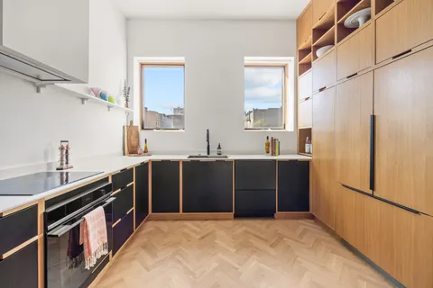 a kitchen with a refrigerator and a sink