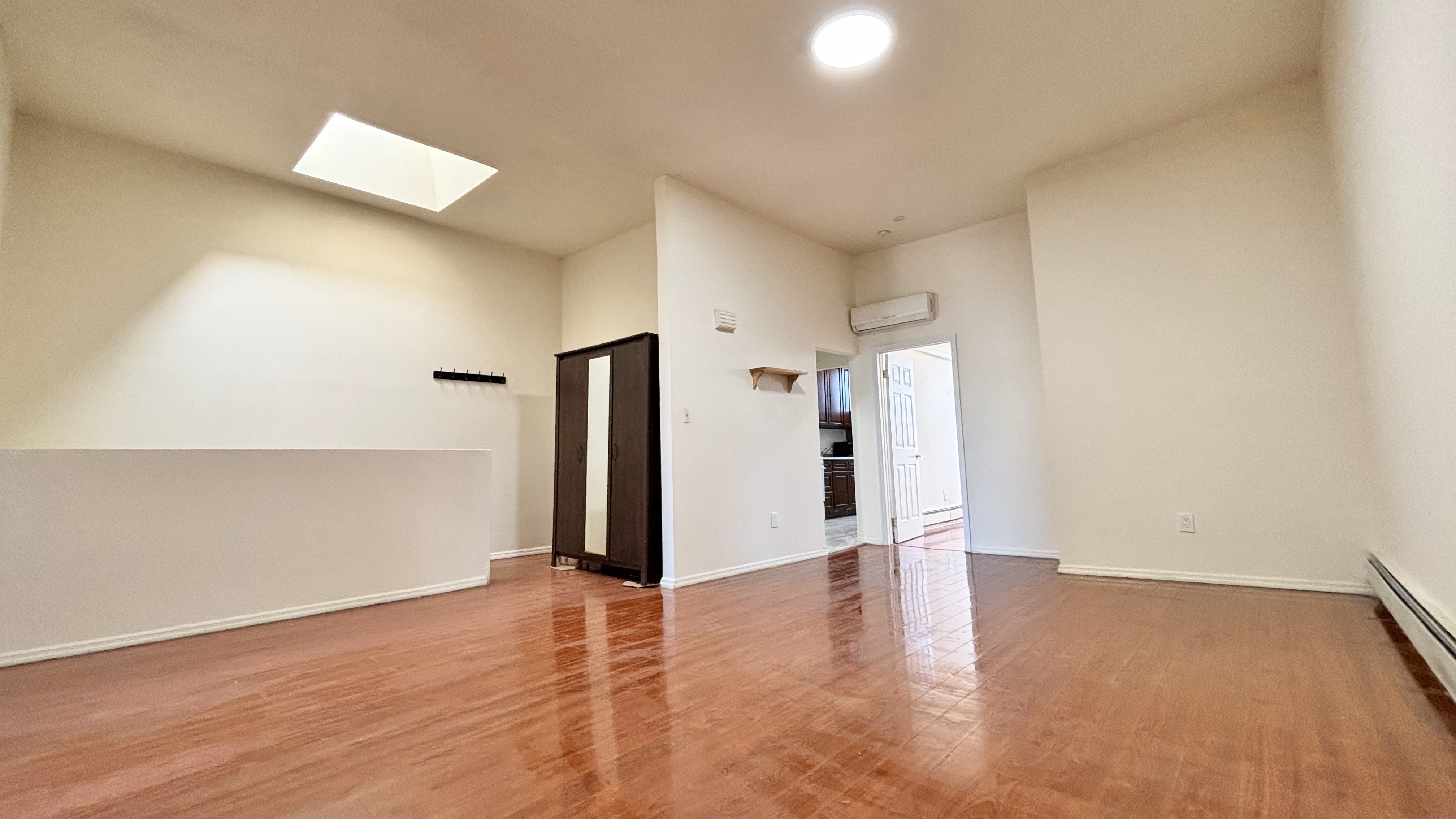 74 Himrod Street, Unit 2 Brooklyn, NY 11221 - Photo 4 of 16 an empty room with wooden floor and windows