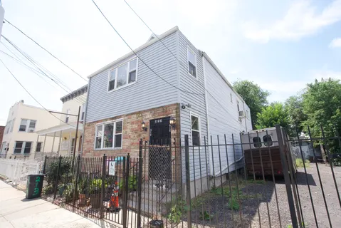 a view of a house with iron fence
