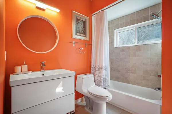 a bathroom with a sink a toilet and a mirror