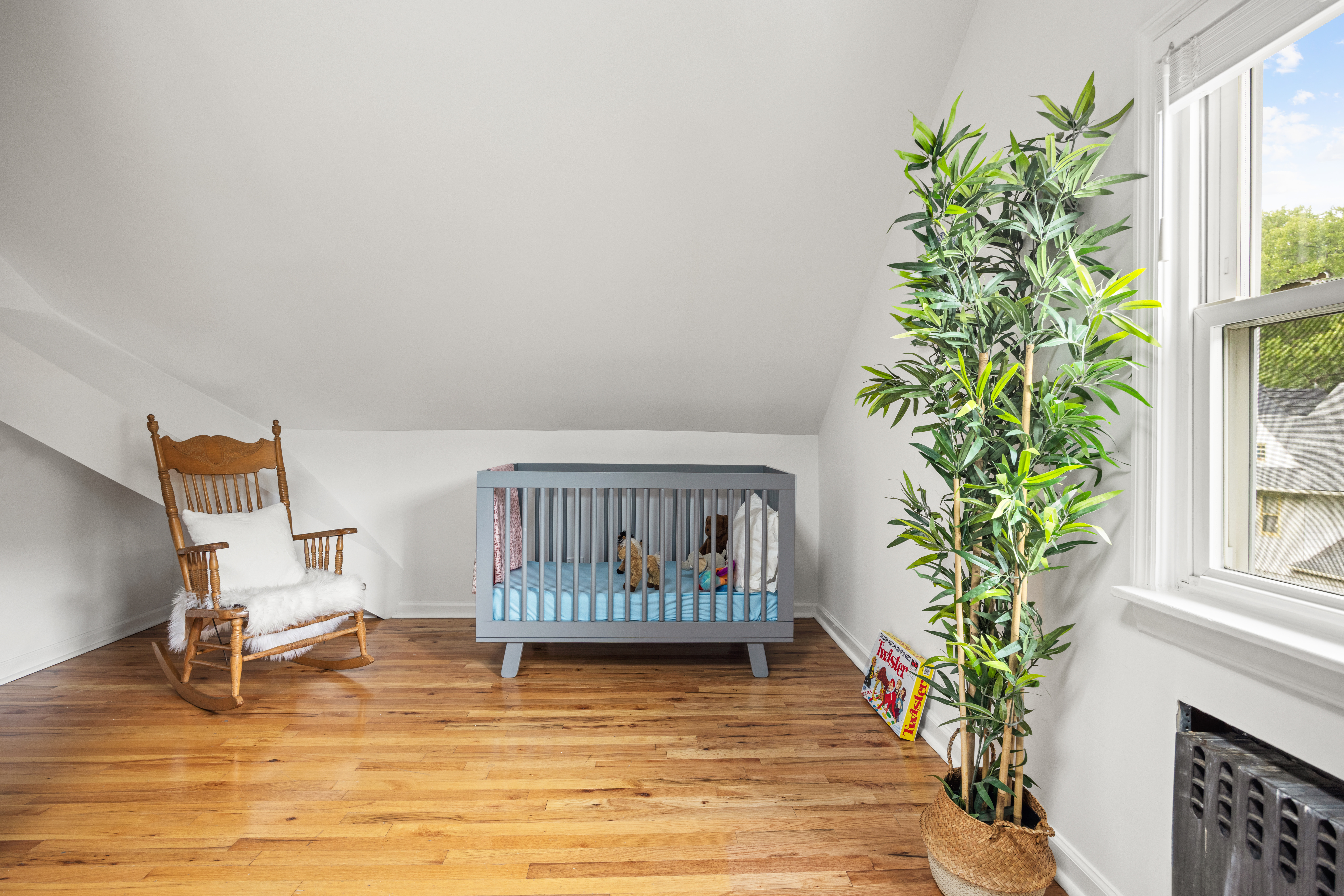 481 Stratford Road Brooklyn, NY 11218 - Photo 21 of 25 a view of a bedroom with wooden floor and a potted plant