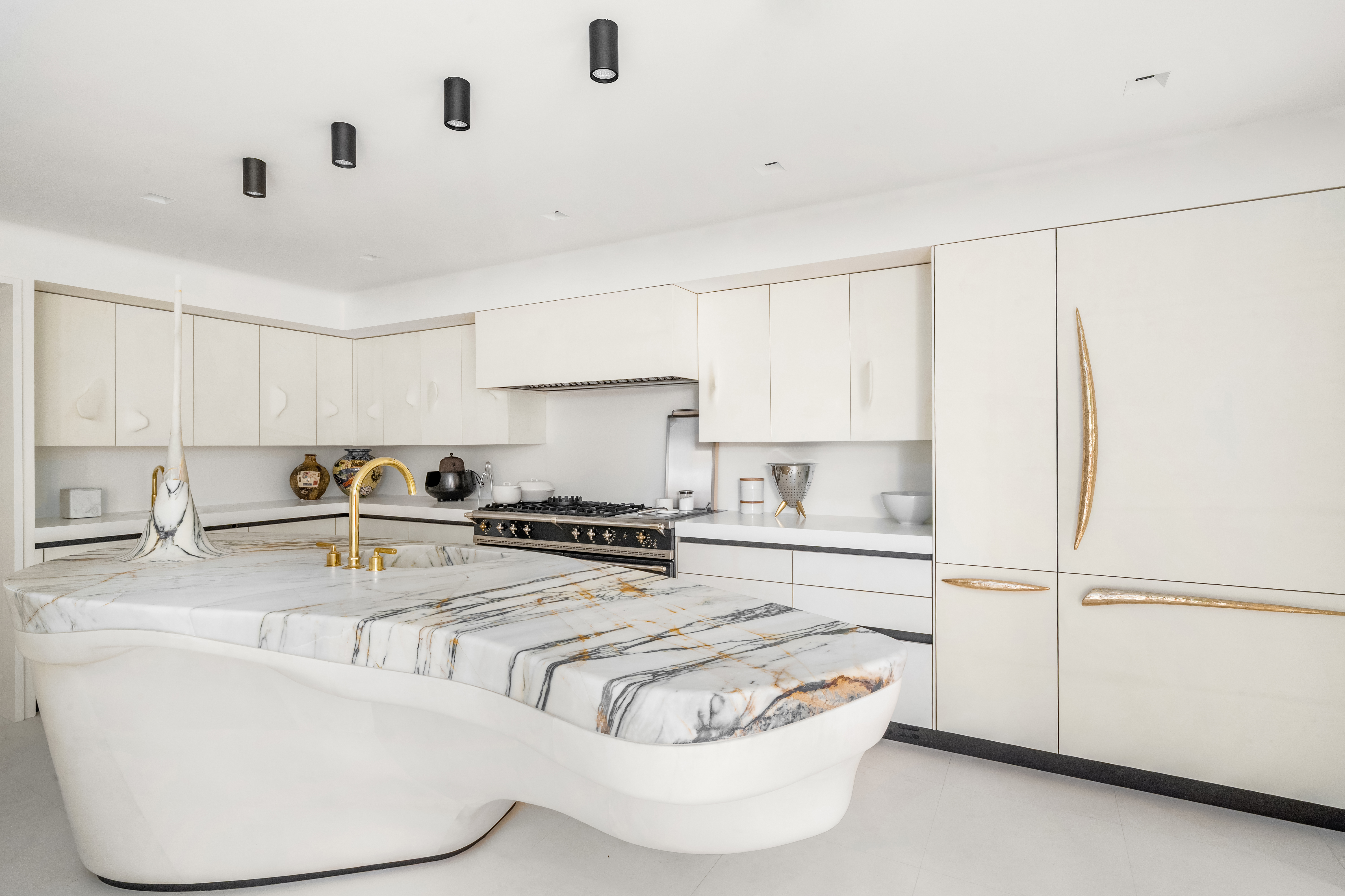 18 East 80th Street Manhattan, NY 10075 - Photo 10 of 28 a kitchen with stainless steel appliances granite countertop a sink a stove and white cabinets