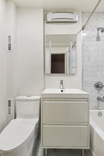 a bathroom with a sink a toilet and a bathtub