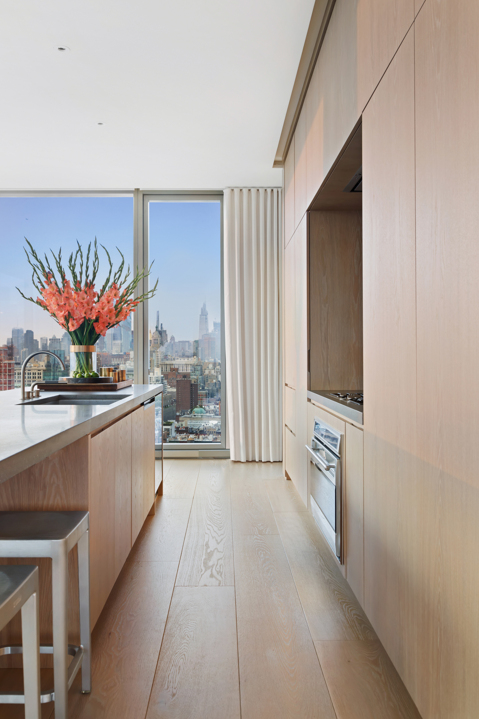 215 Chrystie Street, Unit PH2 Manhattan, NY 10002 - Photo 12 of 30 a large white kitchen with stainless steel appliances a large oven and a refrigerator