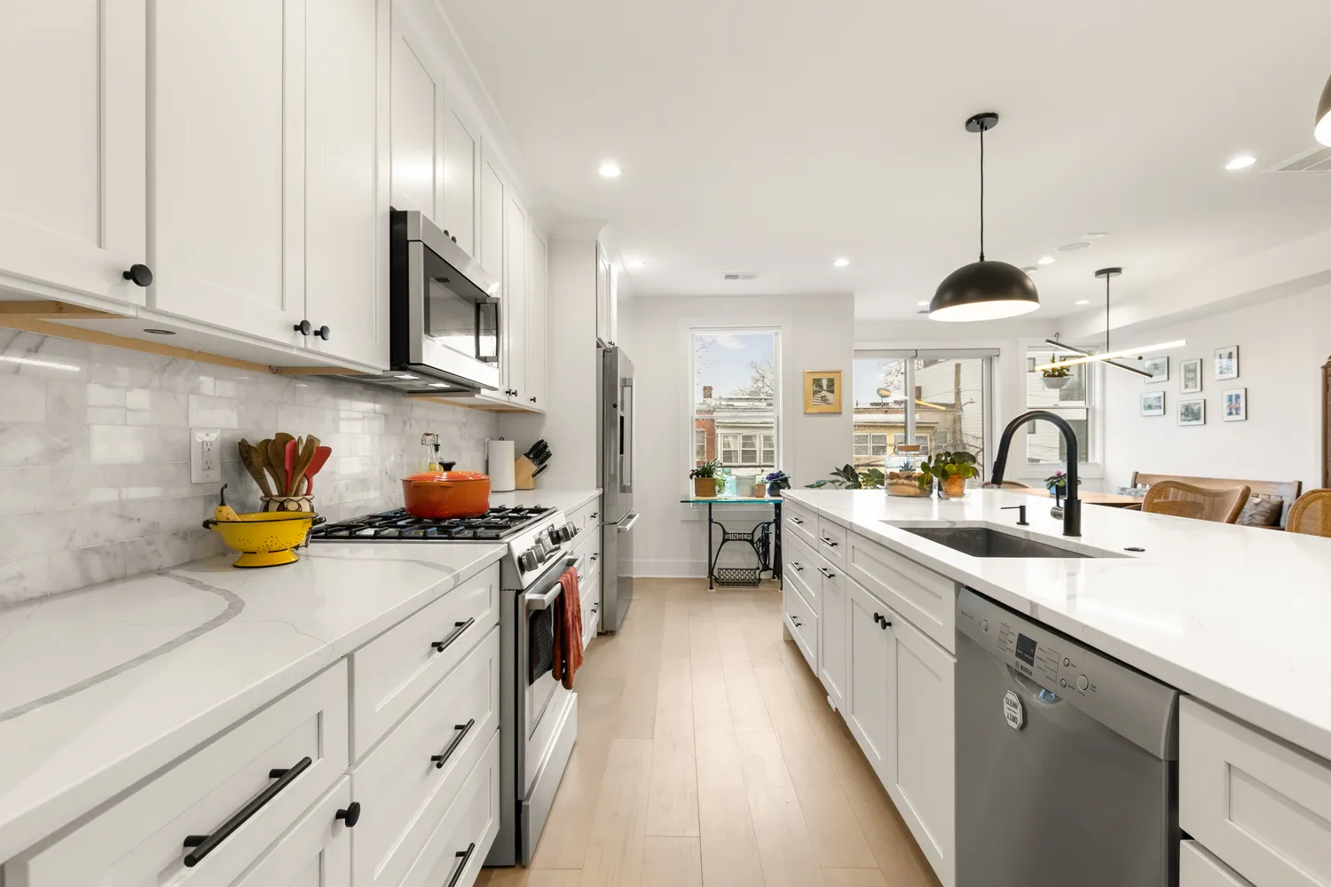 a kitchen with sink a stove and cabinets