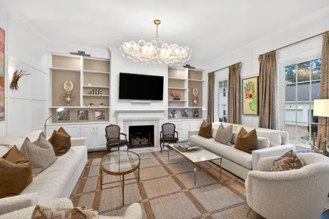 a living room with furniture a flat screen tv and a fireplace