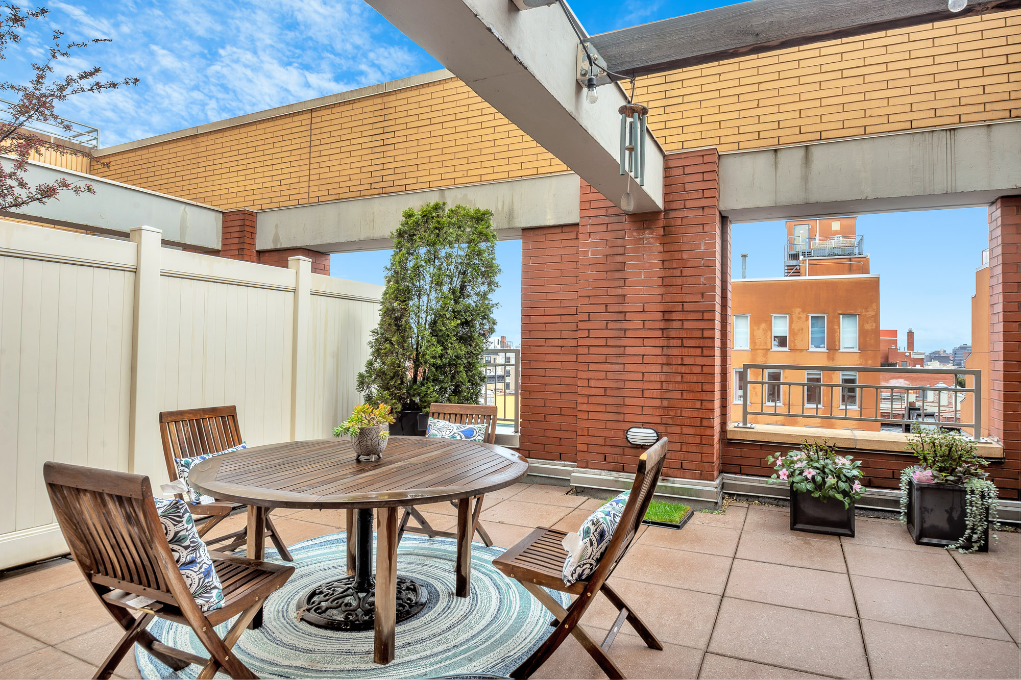 301 West 118th Street, Unit 10G Manhattan, NY 10026 - Photo 8 of 17 a backyard of a house with table and chairs