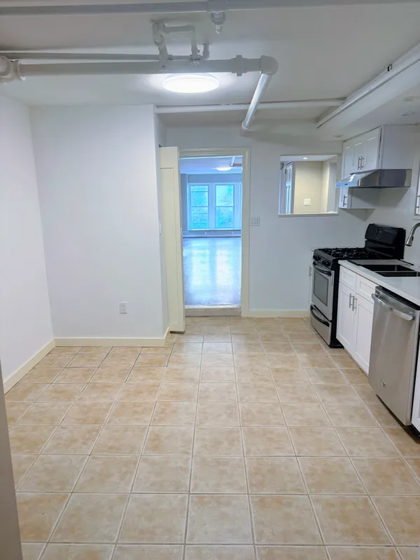 a view of a kitchen with a sink cabinets and a window