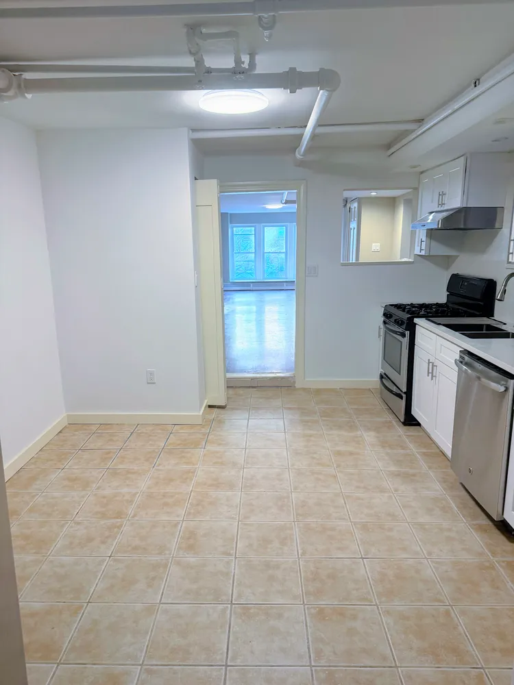 a view of a kitchen with a sink cabinets and a window