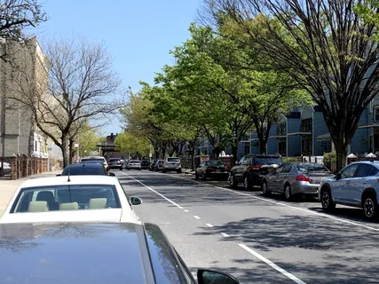a view of a cars park on the side of a road
