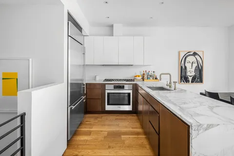 a kitchen with a stove a sink and a refrigerator