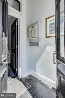 a view of a hallway with windows and entryway