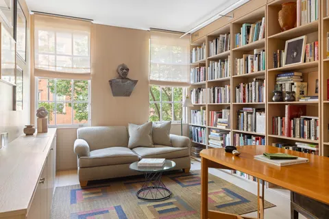 a large bedroom with a bed and a large window