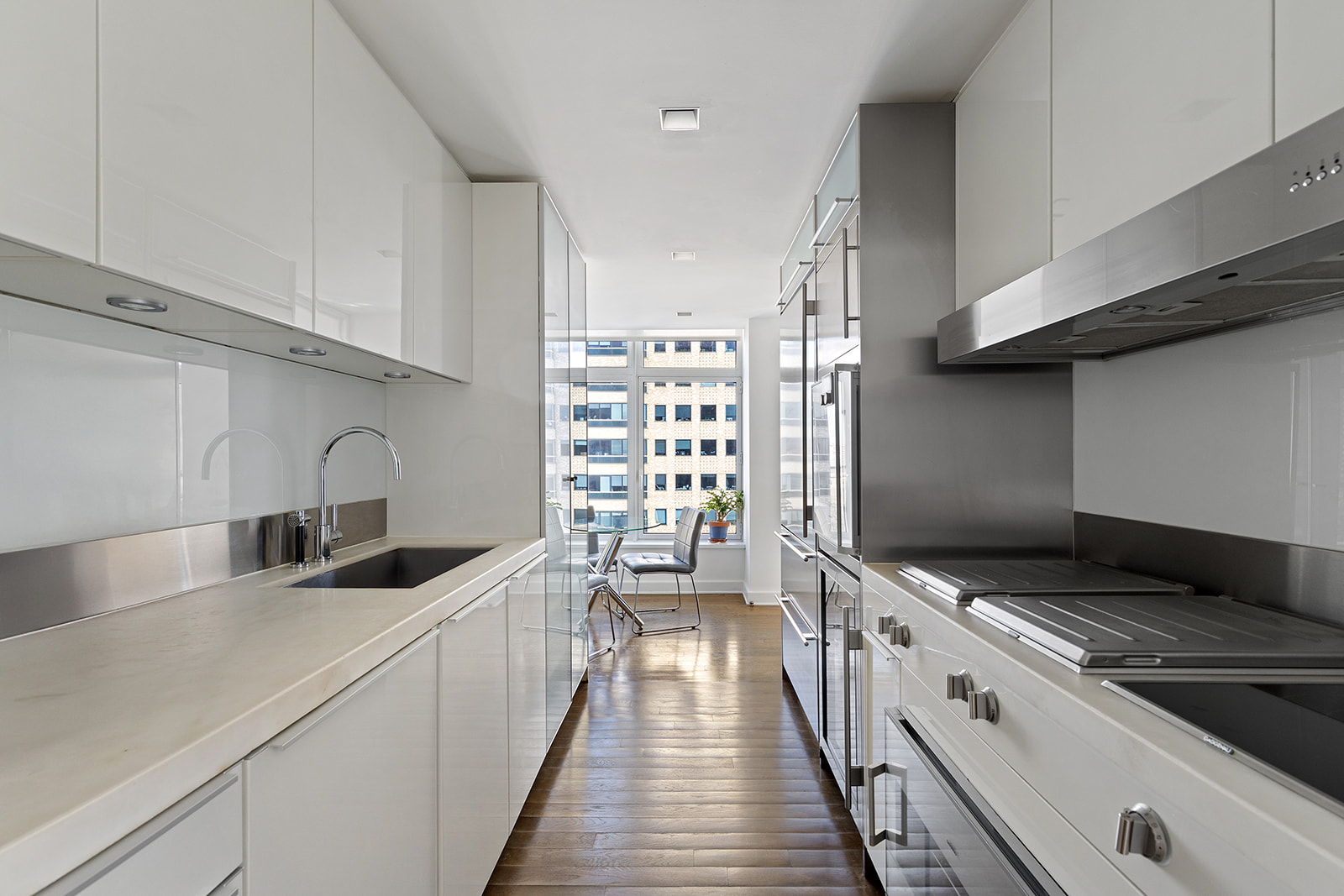 400 East 67th Street, Unit 12D Manhattan, NY 10065 - Photo 2 of 9 a kitchen with granite countertop a sink and a stove top oven